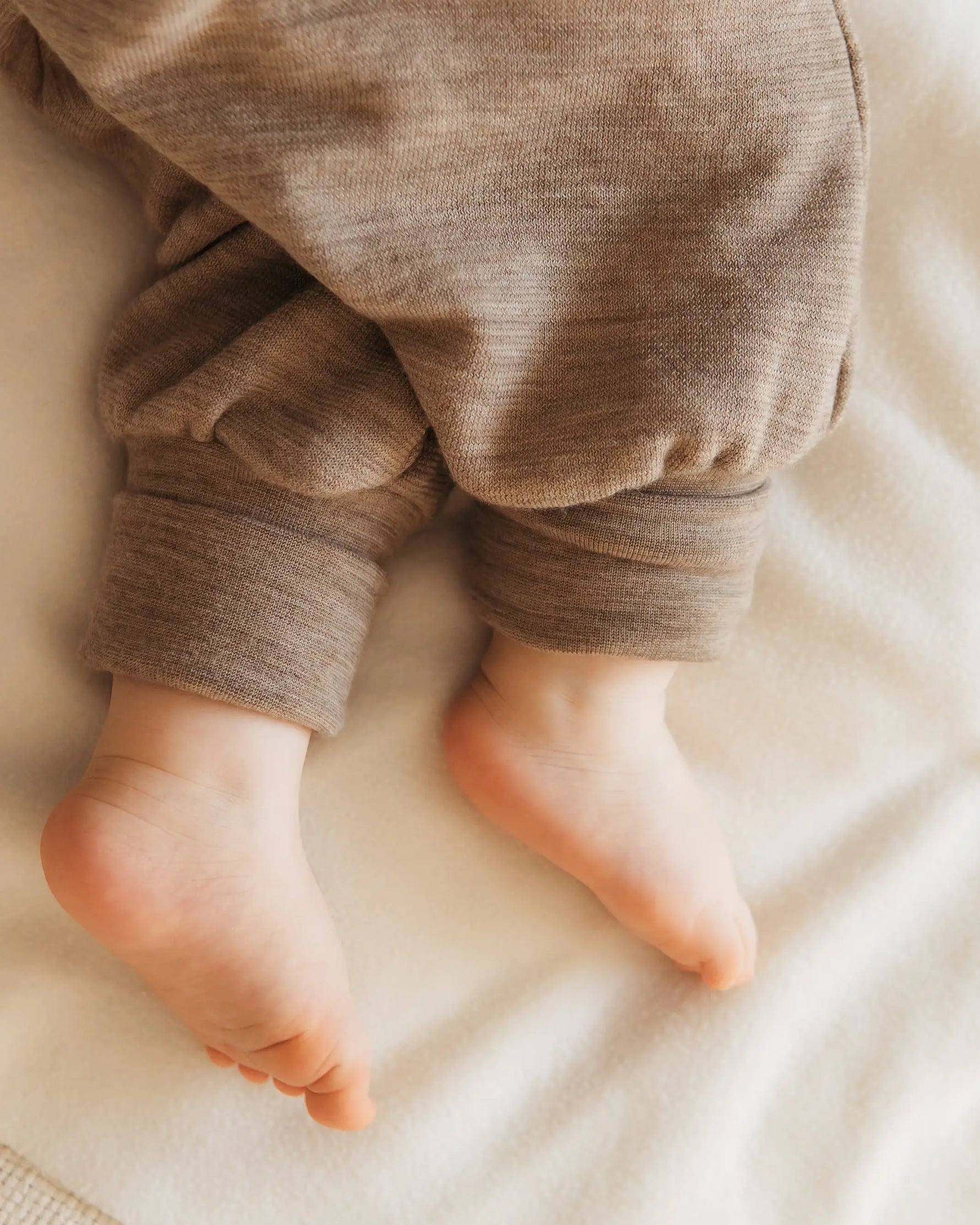 Detailaufnahme eines Schlafsacks mit Füßen aus Wollfrottee, weiche Struktur, mitwachsende wollbündchen und feuchtigkeitsausgleichend
