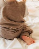 Kleinkind im Sommerschlafsack mit Beinen aus Merinowolle beim Laufen im Schlafzimmer, bewegungsfreundlich und temperaturregulierend